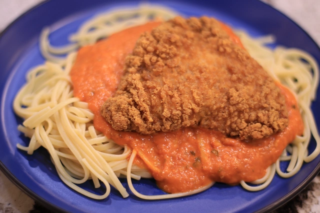 A picture of Chicken Parmigiana on Linguine